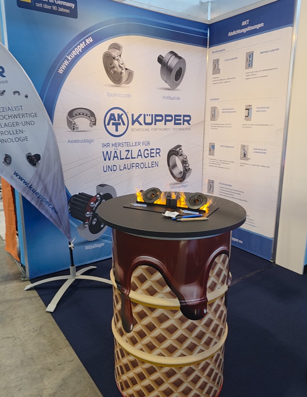 Rolling bearings and track rollers in front of the Küpper product display at Motek 2026